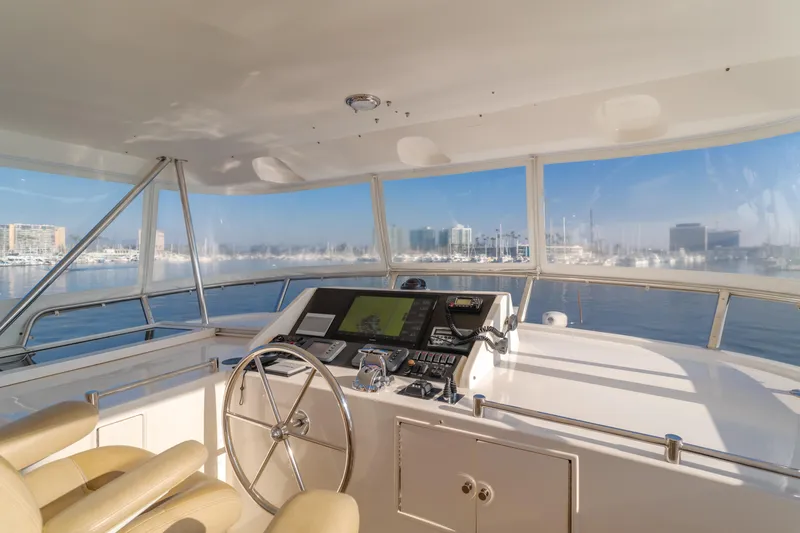 Slide: The Image of Pilothouse interior of 2003 Ocean Alexander 64, featuring navigation equipment and panoramic windows. - 38