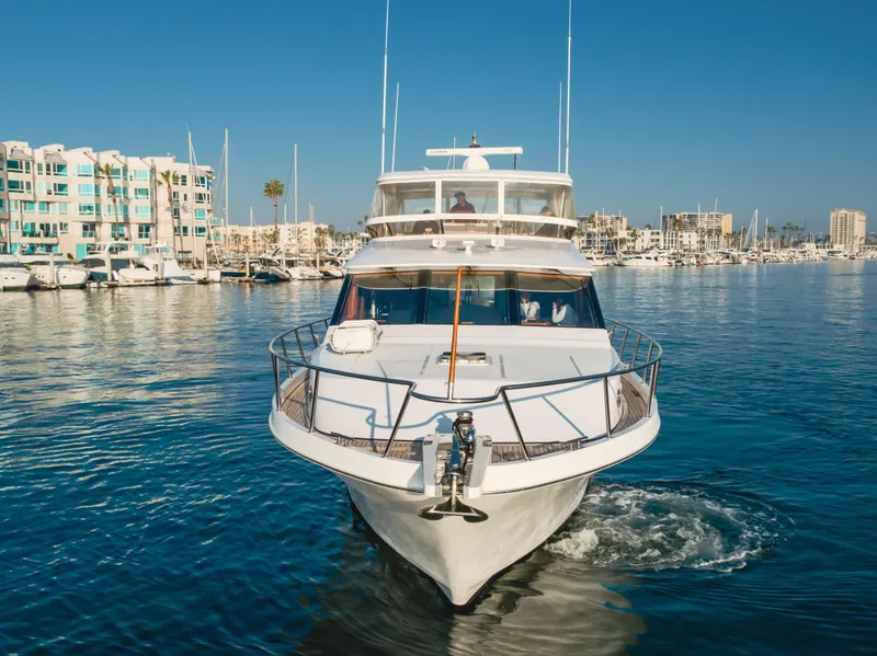 Slide: The Image of 2003 Ocean Alexander 64 Pilothouse yacht cruising in a marina, clear blue sky. - 9