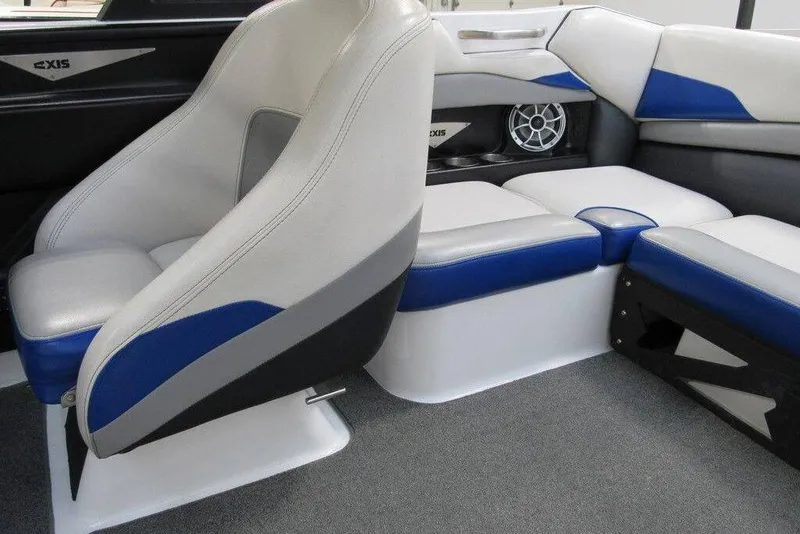 Slide: The Image of 2016 Axis A20 boat interior with white and blue seating, modern dashboard, and spacious layout. - 4