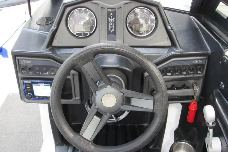 Slide: The Image of 2016 Axis A20 boat interior with blue and gray seating, featuring a speaker system. - 5