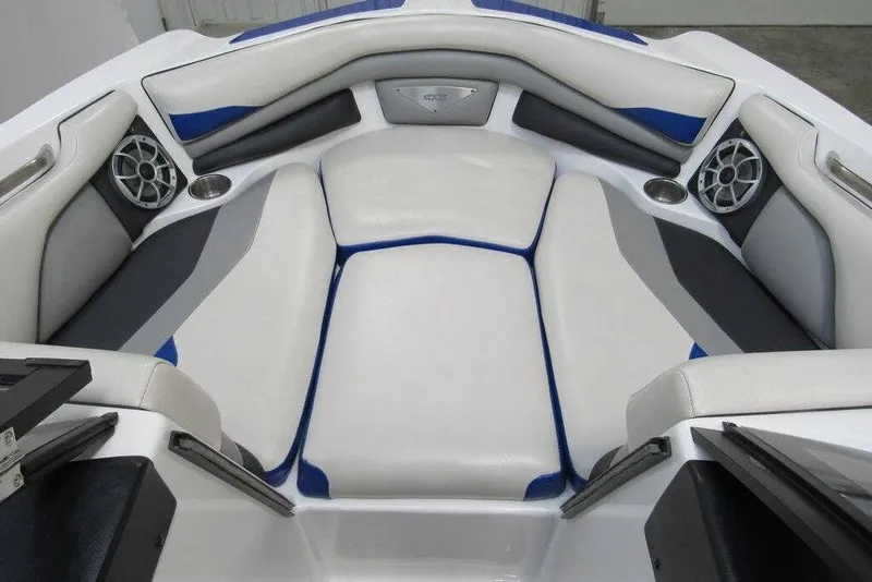 Slide: The Image of 2016 Axis A20 boat interior with cushioned seating and built-in speakers. - 8