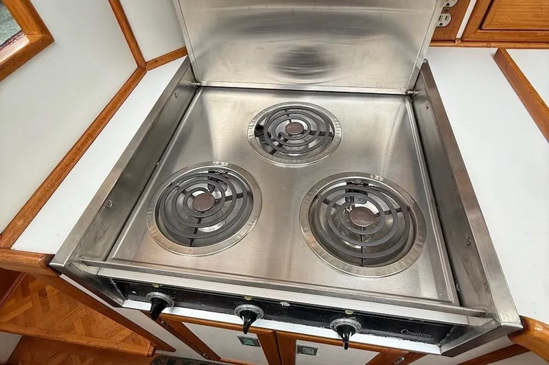 Slide: The Image of Stainless steel three-burner stove in 1990 Nauset Flybridge Cruiser kitchen. - 15