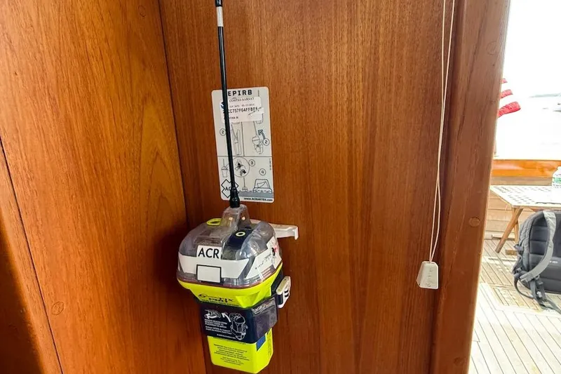 Slide: The Image of EPIRB device mounted on 1990 Nauset Flybridge Cruiser's wooden interior. - 29