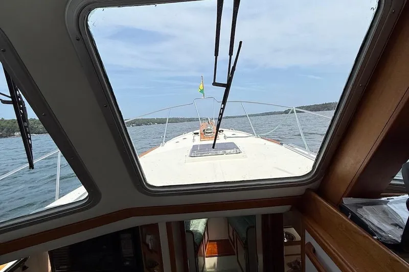 Slide: The Image of Interior view from a 1990 Nauset Flybridge Cruiser with Extended Hardtop, overlooking the water. - 47