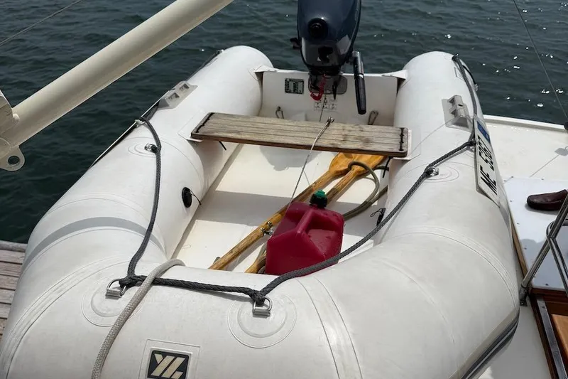 Slide: The Image of Inflatable dinghy with motor and fuel can on Nauset Flybridge Cruiser, 1990 model. - 50