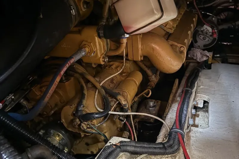 Slide: The Image of Engine compartment of a 1990 Nauset Flybridge Cruiser with Extended Hardtop, showcasing detailed components. - 57