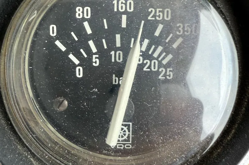 Slide: The Image of Close-up of a vintage Nauset Flybridge Cruiser pressure gauge, displaying bar measurements. - 60