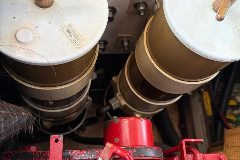 Slide: The Image of Engine components of a 1990 Nauset Flybridge Cruiser with extended hardtop, featuring Racor filters. - 68