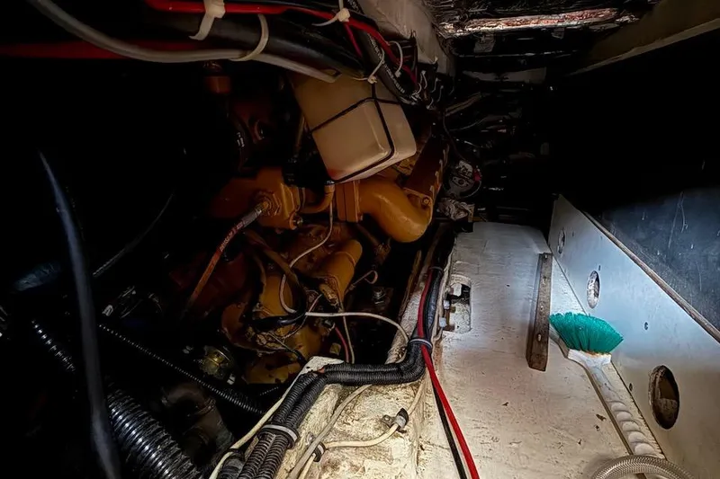 Slide: The Image of Engine room of a 1990 Nauset Flybridge Cruiser with visible wiring and components. - 70