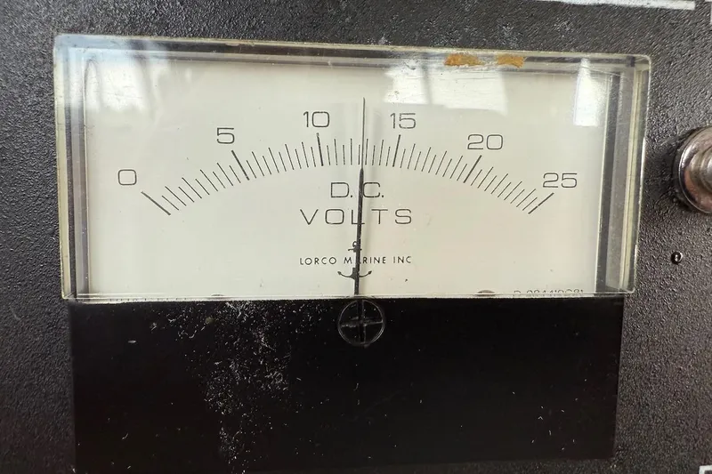 Slide: The Image of DC voltmeter on 1990 Nauset Flybridge Cruiser, displaying voltage range from 0 to 25 volts. - 71