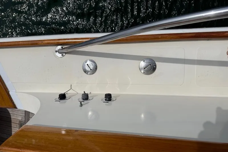Slide: The Image of 1990 Nauset Flybridge Cruiser deck with railing and control panel, overlooking water. - 72