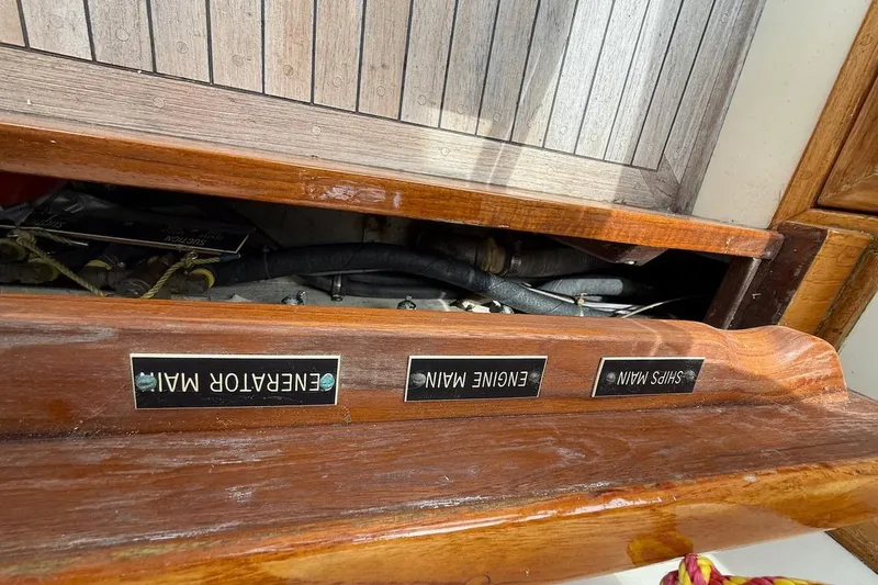 Slide: The Image of 1990 Nauset Flybridge Cruiser engine compartment with labeled controls: Generator, Engine, Ship's Main. - 73