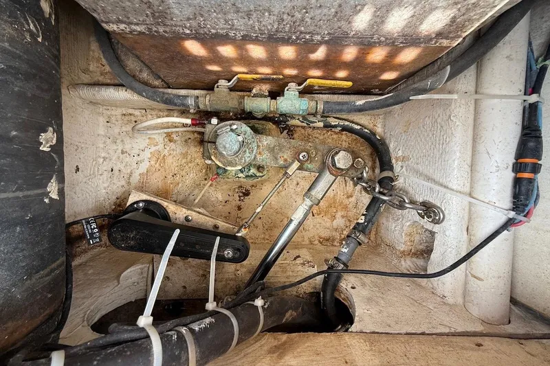 Slide: The Image of Engine compartment of 1990 Nauset Flybridge Cruiser, showing mechanical components and wiring. - 75