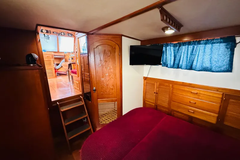 Slide: The Image of Cozy cabin interior of 1984 Chien Hwa 35 Trawler with wood paneling and TV. - 12