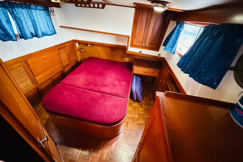 Slide: The Image of Cozy cabin interior of 1984 Chien Hwa 35 Trawler with red bedding and wooden furnishings. - 13