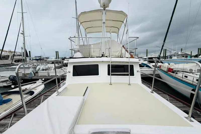 Slide: The Image of 1984 Chien Hwa 35 Trawler docked at marina under cloudy skies. - 15