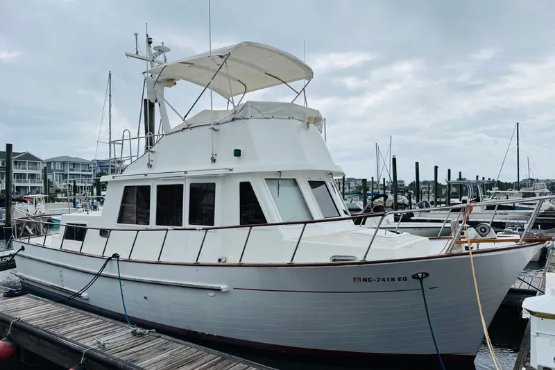 Slide: The Image of 1984 Chien Hwa 35 Trawler docked at marina under cloudy sky. - 3