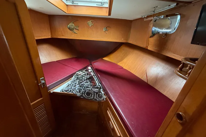 Slide: The Image of 1984 Chien Hwa 35 Trawler cabin with red cushions and wooden interior. - 4