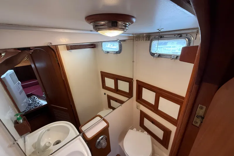 Slide: The Image of 1984 Chien Hwa 35 Trawler bathroom with sink, toilet, and wooden accents. - 9