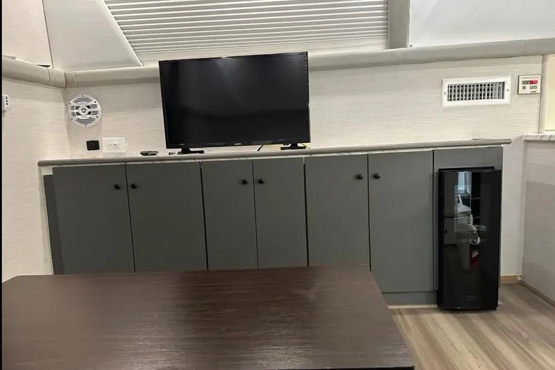 Slide: The Image of Interior of 1995 Silverton 34 Convertible with TV, cabinets, and mini fridge. - 10