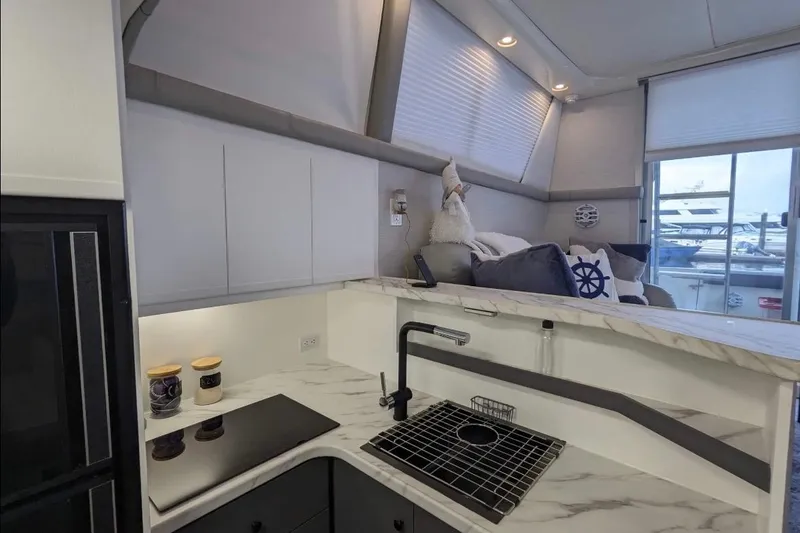 Slide: The Image of Interior of 1995 Silverton 34 Convertible yacht with modern kitchen and cozy seating area. - 13