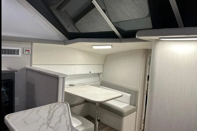 Slide: The Image of Interior of a 1995 Silverton 34 Convertible yacht with modern seating and table. - 14