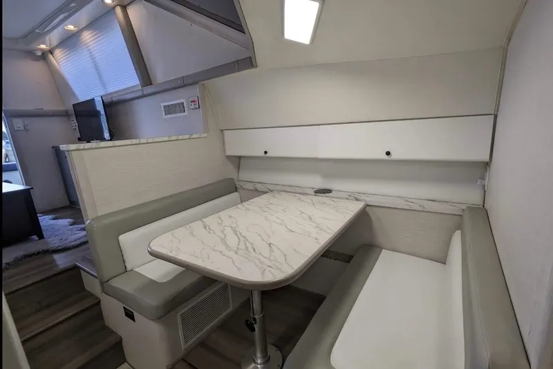 Slide: The Image of Interior of 1995 Silverton 34 Convertible yacht with modern dining area and seating. - 15
