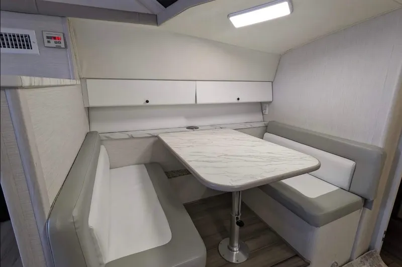 Slide: The Image of 1995 Silverton 34 Convertible interior with modern dinette and cushioned seating. - 16