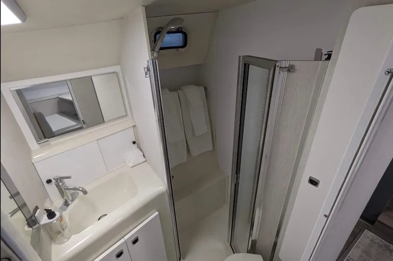 Slide: The Image of Bathroom interior of 1995 Silverton 34 Convertible yacht with sink and shower. - 17