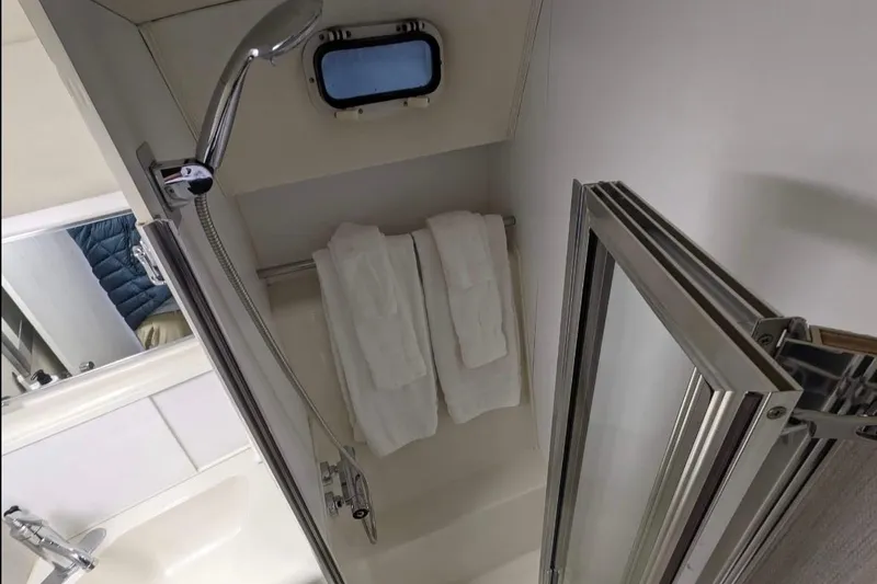 Slide: The Image of Bathroom interior of 1995 Silverton 34 Convertible yacht with shower and towels. - 18