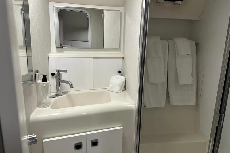 Slide: The Image of Bathroom interior of 1995 Silverton 34 Convertible yacht with sink and shower. - 19