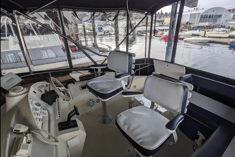 Slide: The Image of Interior of a 1995 Silverton 34 Convertible boat with helm and seating. - 2