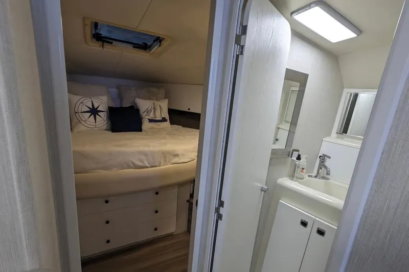 Slide: The Image of 1995 Silverton 34 Convertible interior with cozy bedroom and compact bathroom. - 20