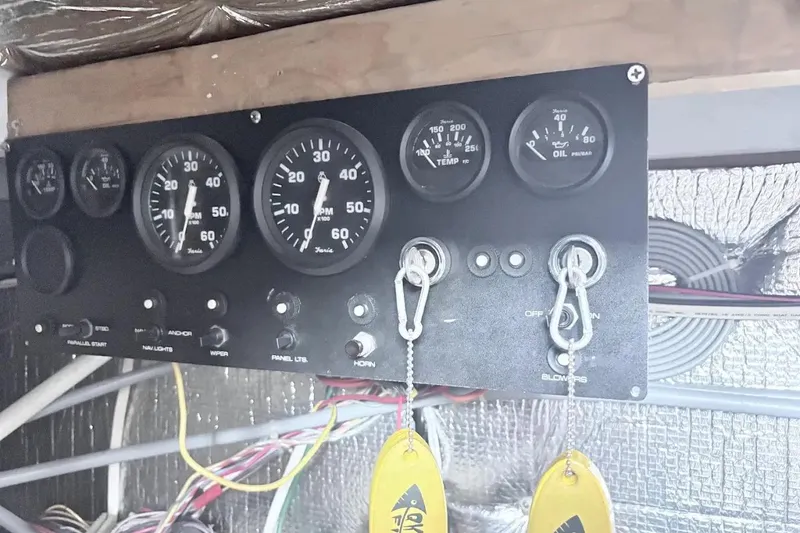 Slide: The Image of Control panel of a 1995 Silverton 34 Convertible boat with gauges and switches. - 26