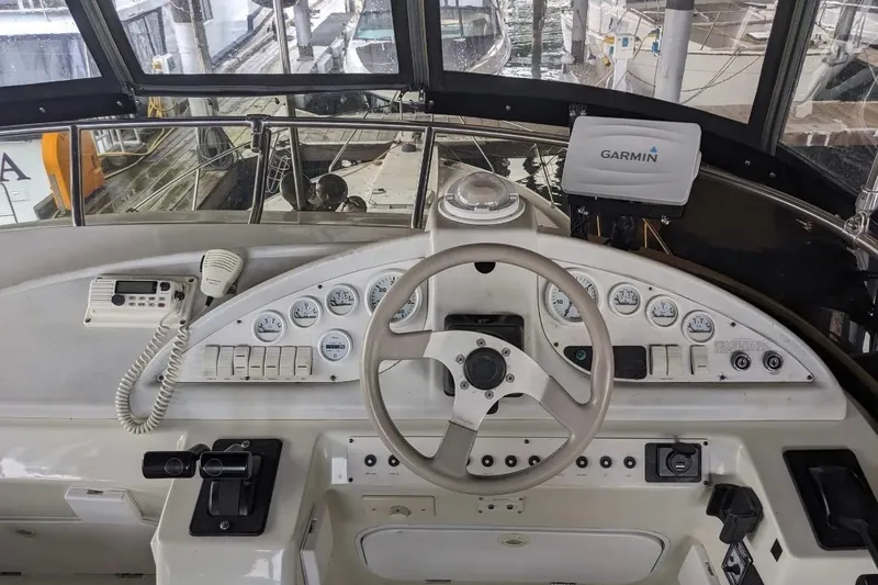 Slide: The Image of 1995 Silverton 34 Convertible helm with Garmin navigation, gauges, and communication equipment. - 3