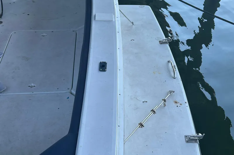 Slide: The Image of 1995 Silverton 34 Convertible boat deck with metal fittings and water reflection. - 30