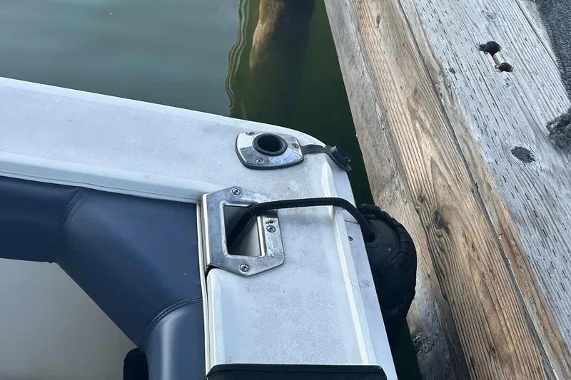 Slide: The Image of 1995 Silverton 34 Convertible boat docked, showing mooring line and wooden pier. - 32