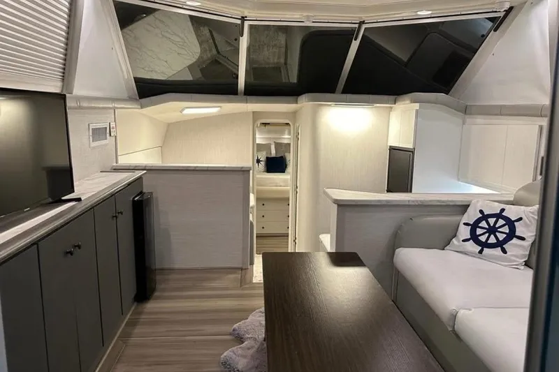 Slide: The Image of Interior of 1995 Silverton 34 Convertible yacht, featuring modern furnishings and nautical decor. - 5