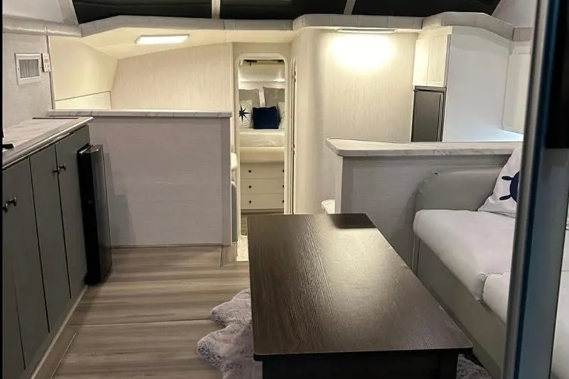 Slide: The Image of Interior of a 1995 Silverton 34 Convertible yacht, featuring modern furnishings and cozy seating. - 6