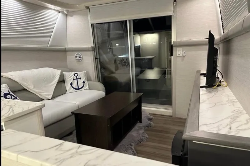 Slide: The Image of Interior of a 1995 Silverton 34 Convertible yacht with modern decor and nautical accents. - 9