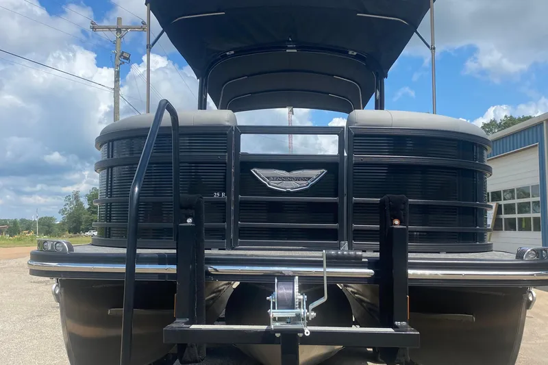 Slide: The Image of 2023 Bennington 25RSBA pontoon boat front view with blue sky background. - 13