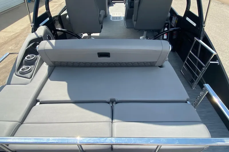 Slide: The Image of 2023 Bennington 25RSBA boat interior with gray seating and cup holders. - 14