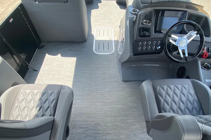 Slide: The Image of 2023 Bennington 25RSBA boat interior with modern dashboard and luxurious seating. - 15