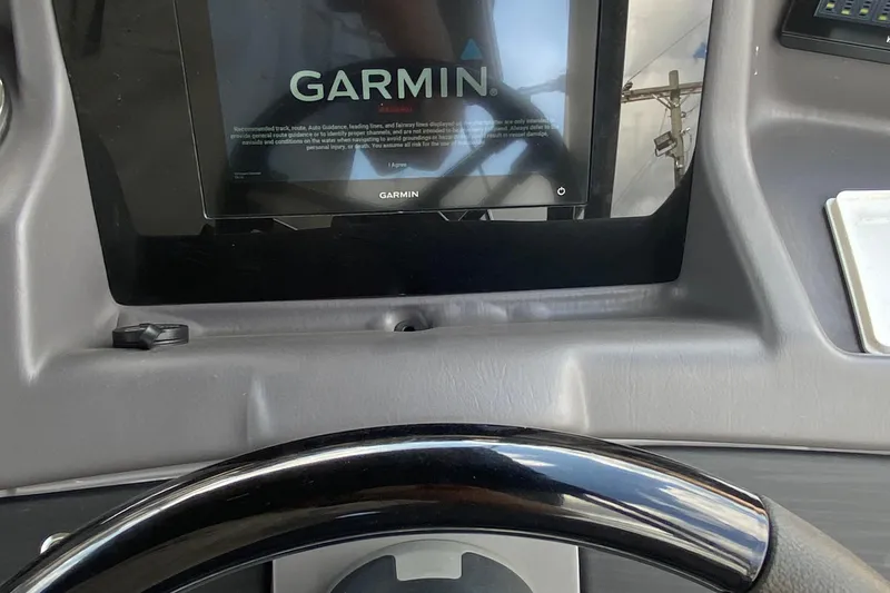 Slide: The Image of Garmin display on 2023 Bennington 25RSBA boat dashboard with steering wheel. - 17