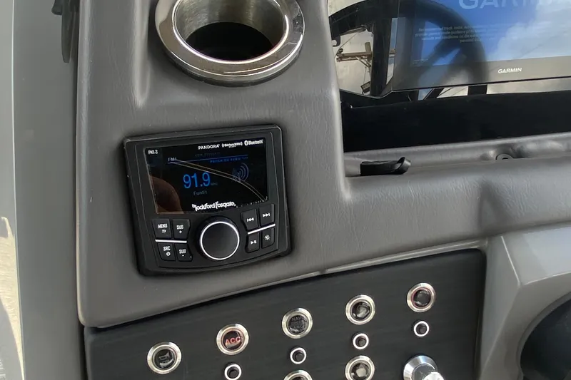 Slide: The Image of 2023 Bennington 25RSBA dashboard with Rockford Fosgate stereo and Garmin display. - 18