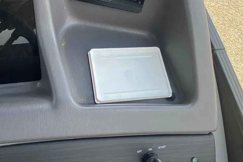 Slide: The Image of Dashboard of 2023 Bennington 25RSBA boat with control panel and storage compartment. - 19