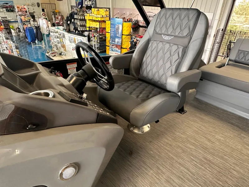 Slide: The Image of 2023 Bennington 25RSBA boat interior with luxurious captain's chair and steering wheel. - 3