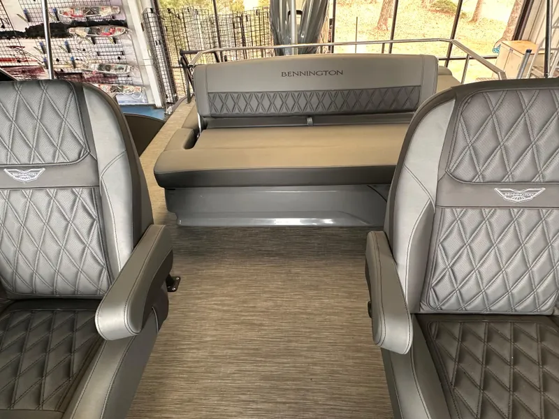 Slide: The Image of 2023 Bennington 25RSBA boat interior with luxurious gray seating and diamond stitching. - 7