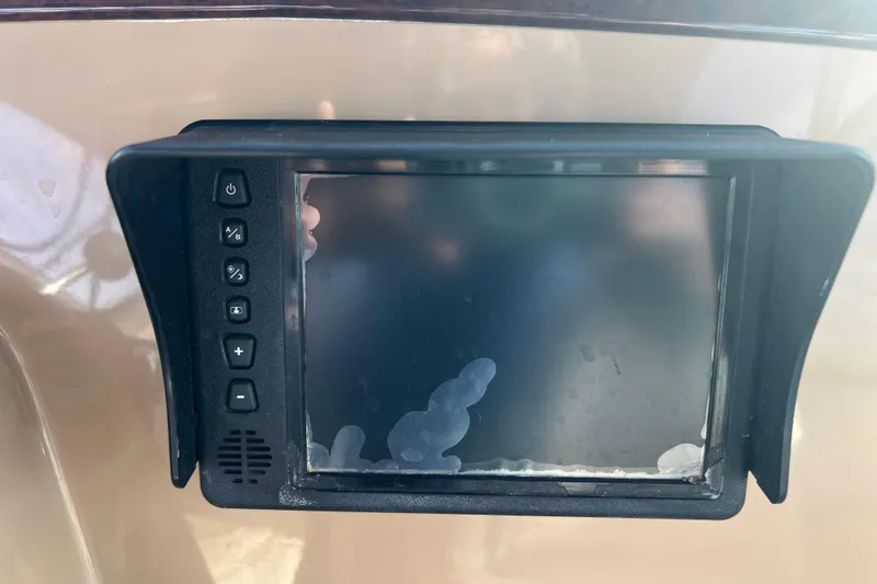 Slide: The Image of Control panel of a 2004 Carver 466 MY boat with buttons and screen. - 14