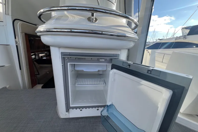 Slide: The Image of Open mini fridge on 2004 Carver 466 MY yacht deck, with marina view. - 18